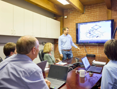 dyhydromatics employees in a meeting working on a high pressure homogenizer process